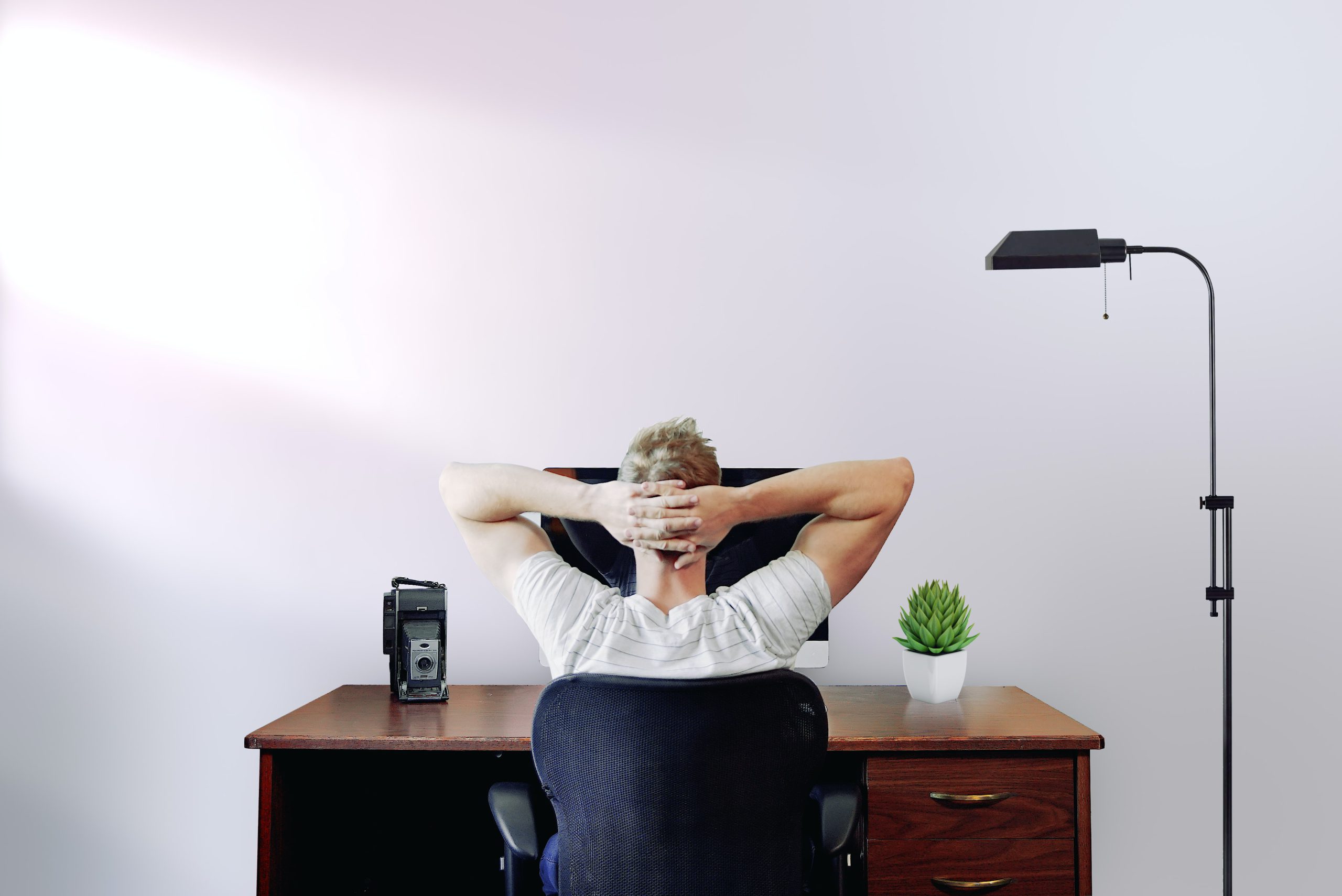Unique icebreaker questions section image with guy sitting relaxed on his laptop