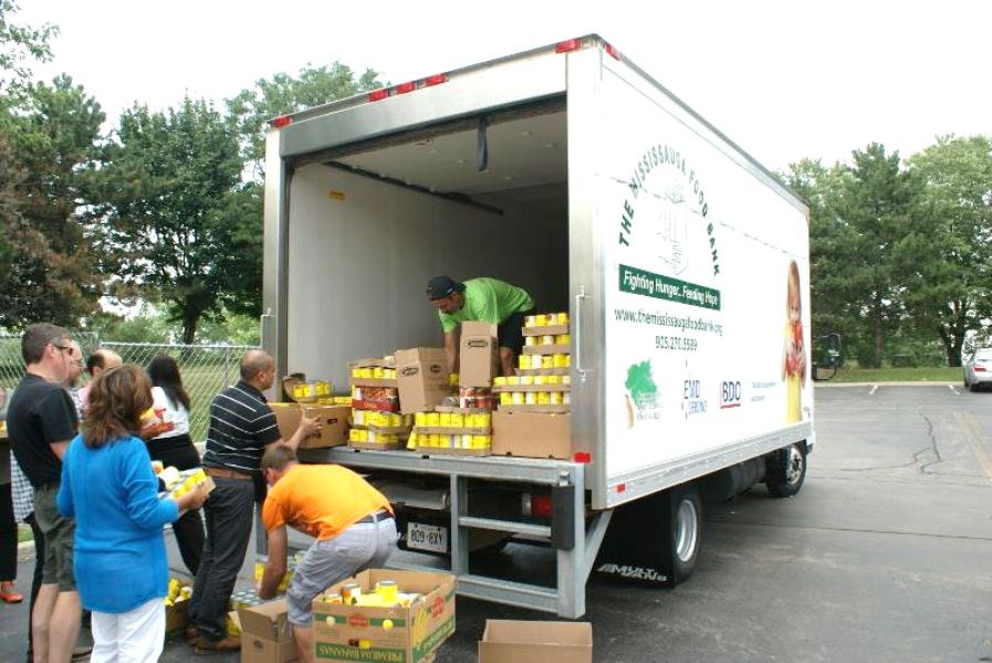a group of colleagues donating to a food bank as a holiday gift idea