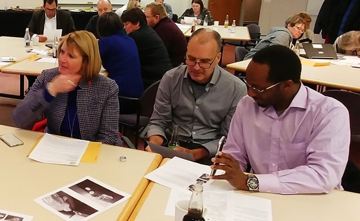a group of colleagues doing a clue murder mystery off site team building activity
