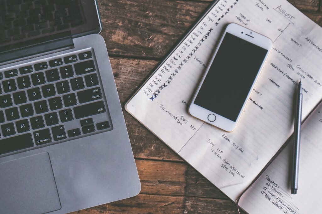 a remote employees first week and three month itinerary in a notebook