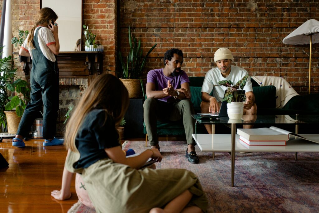 a team of colleagues playing icebreaker games as a fun fast team building activity while sitting in their office lounge