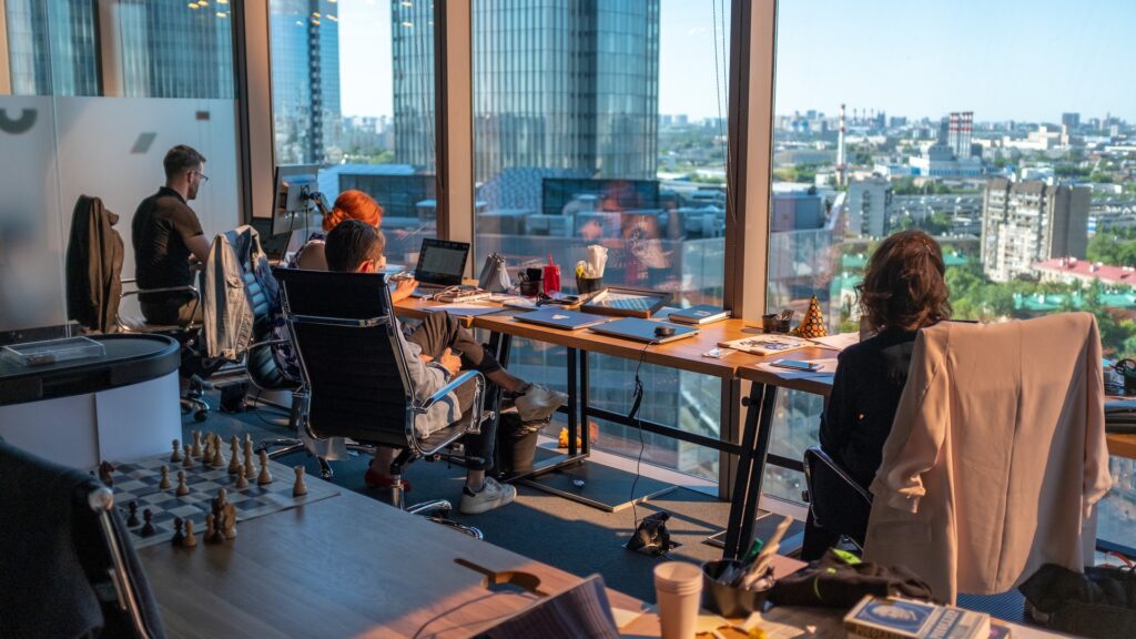 colleagues working in a beautiful office space looking out a window