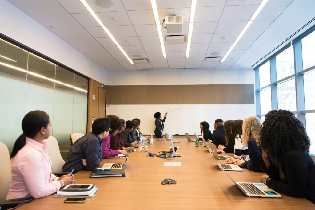 Employees attending workplace training session in office conference room