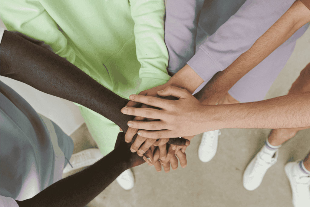 Employees piling hands together during a team building activity