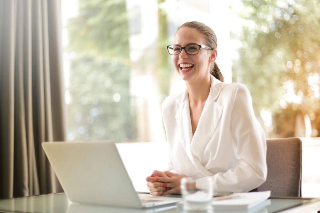 Happy businesswoman on virtual meeting in bright office setting