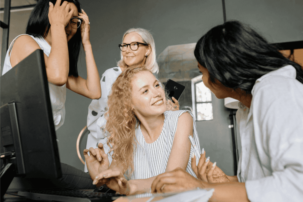 Four colleagues socializing in a workspace