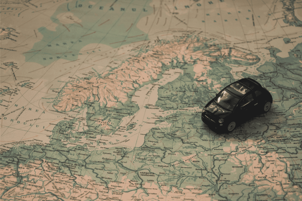 travel planning with small car model on vintage map