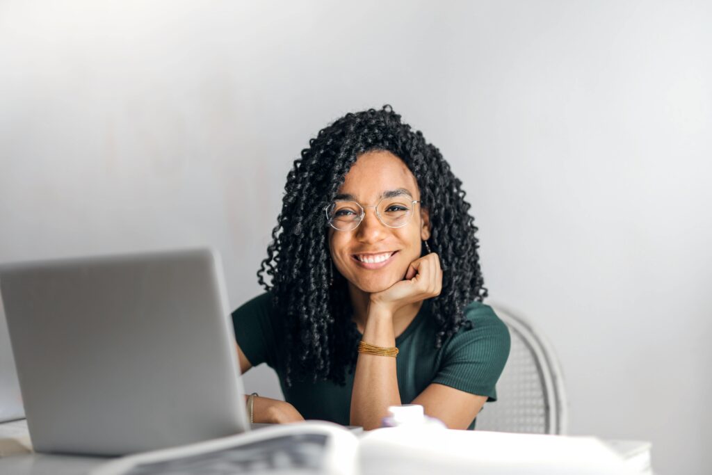 Happy and motivated remote worker smiling in her home office