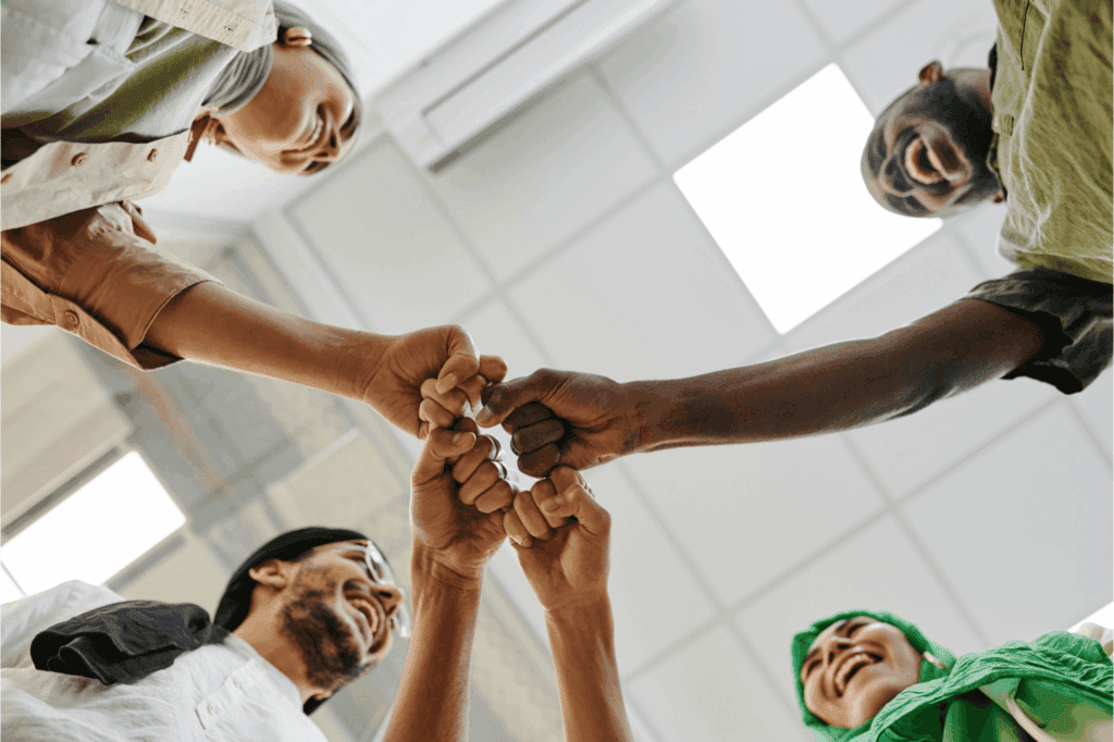 Team celebrating unity with a group fist bump