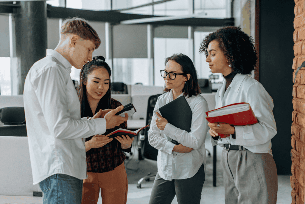 Diverse team of professionals collaborating and discussing ideas in a modern office