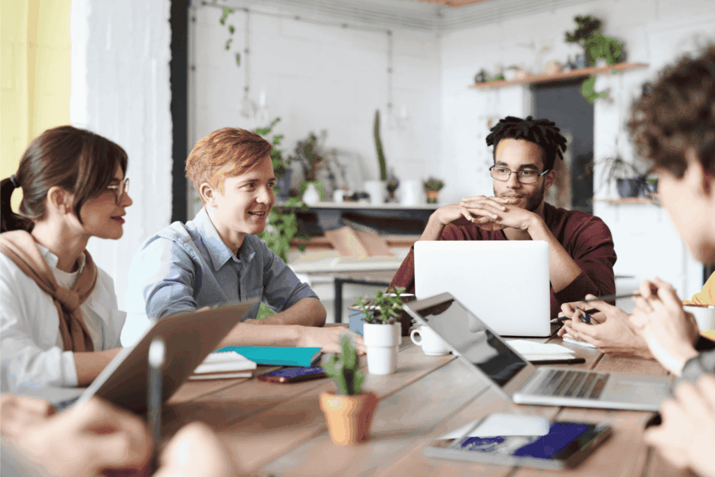 Young professionals collaborate in a modern office space during a creative team meeting