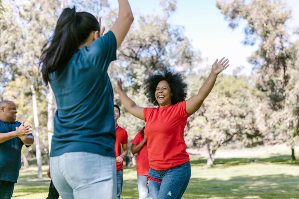 Coworkers celebrate and connect through outdoor team building games in a vibrant company retreat