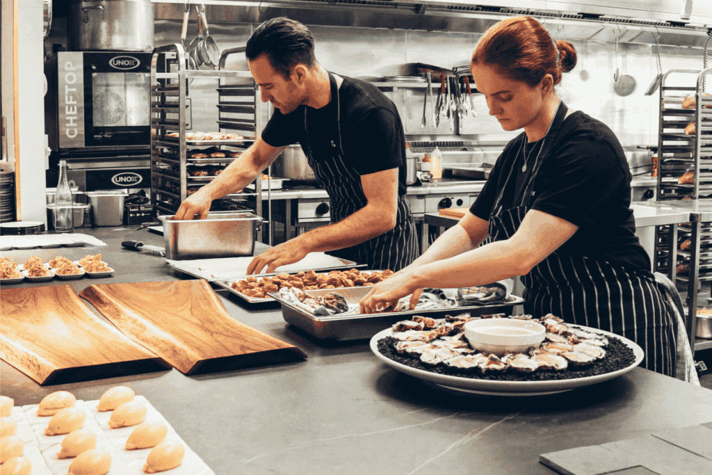 Professional caterers preparing gourmet dishes for a corporate event