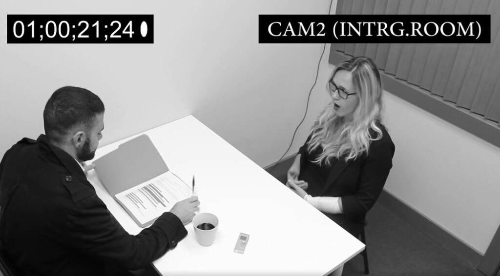 An interrogation between two people at a table 