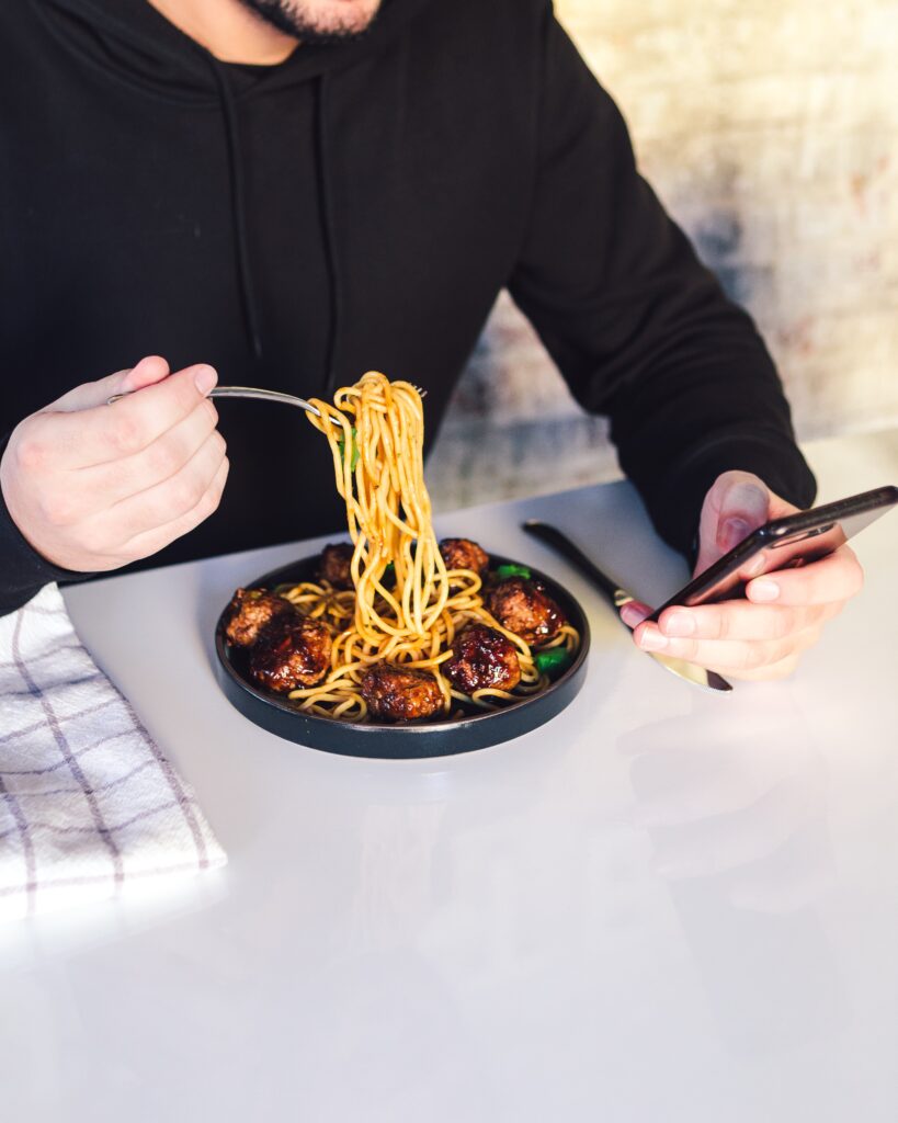 Food-related ice breaker question ideas section image with guy eating spaghetti   and meat balls