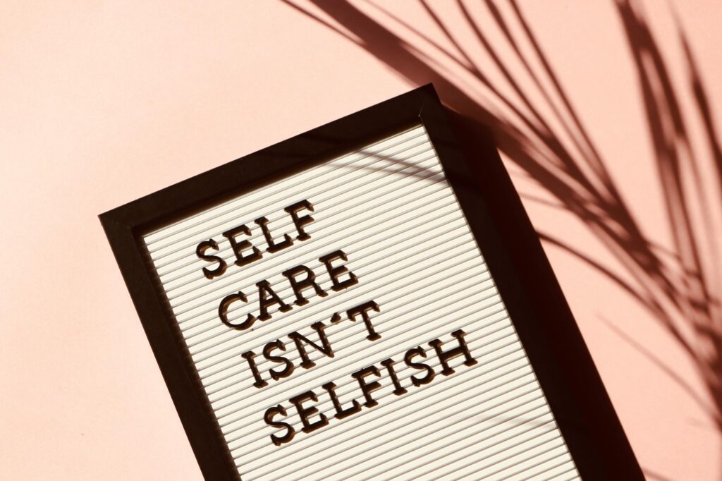 Motivational self-care quote on a letter board, promoting mental health and wellness in a remote work lifestyle