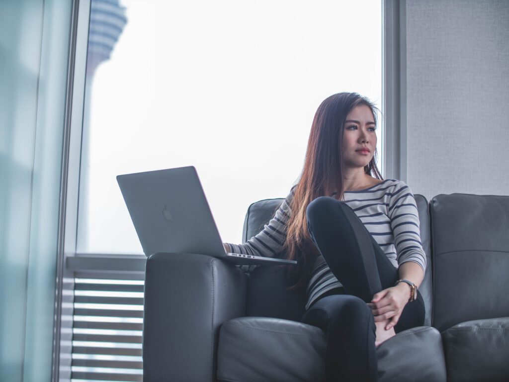 Would you rather ice breaker questions section image with girl sitting on couch with laptop