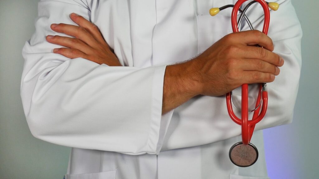 a doctor holding a stethoscope talking about health