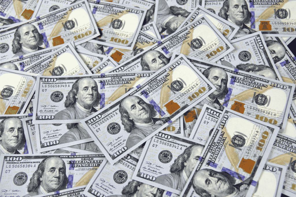 Stacks of hundred-dollar bills represent competitive salaries in employee packages.