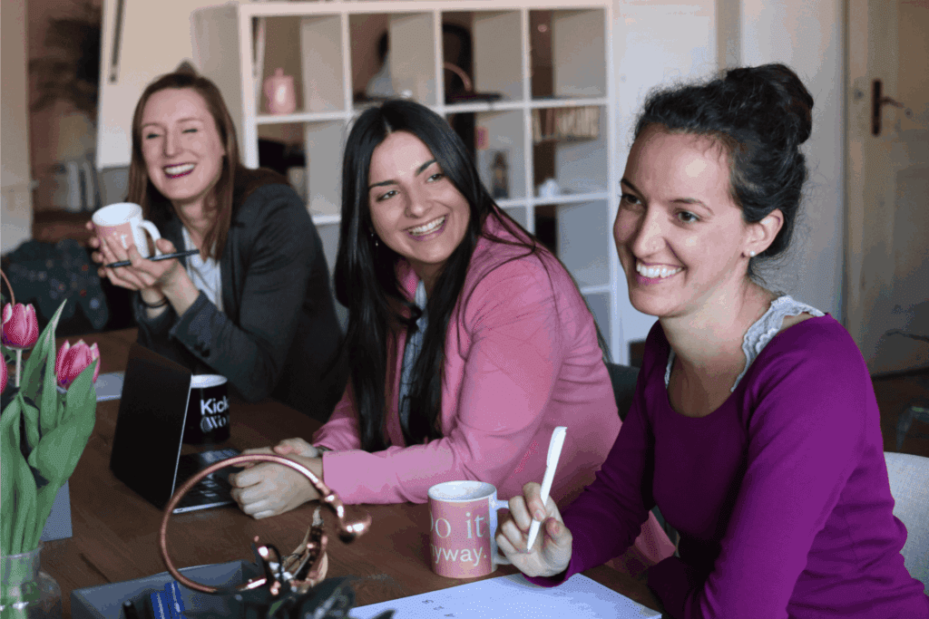 Group of smiling women collaborating in a modern office meeting