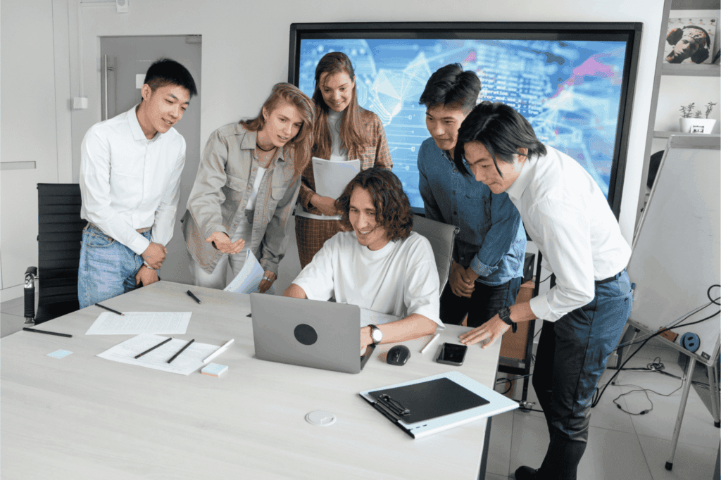 Team of professionals collaborating on a project in a modern office meeting.