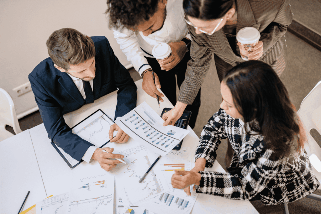 Business team reviewing financial charts and data reports during a corporate strategy meeting.