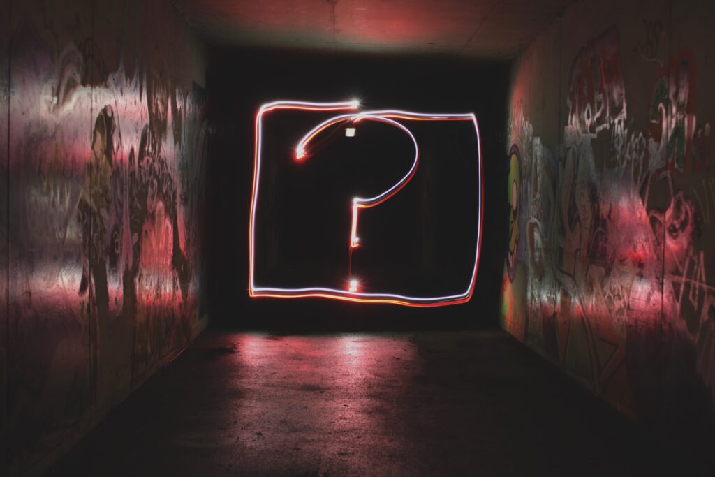 a neon question mark for would you rather questions