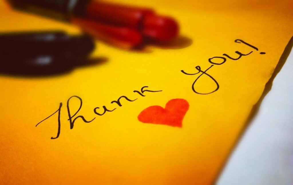 Handwritten card that says "thank you" in cursive 