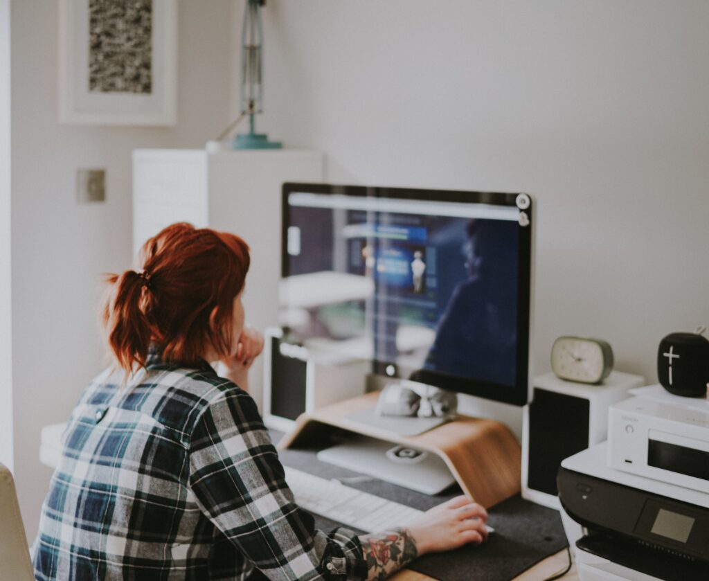 a hybrid employee in her home office working with her remote employer