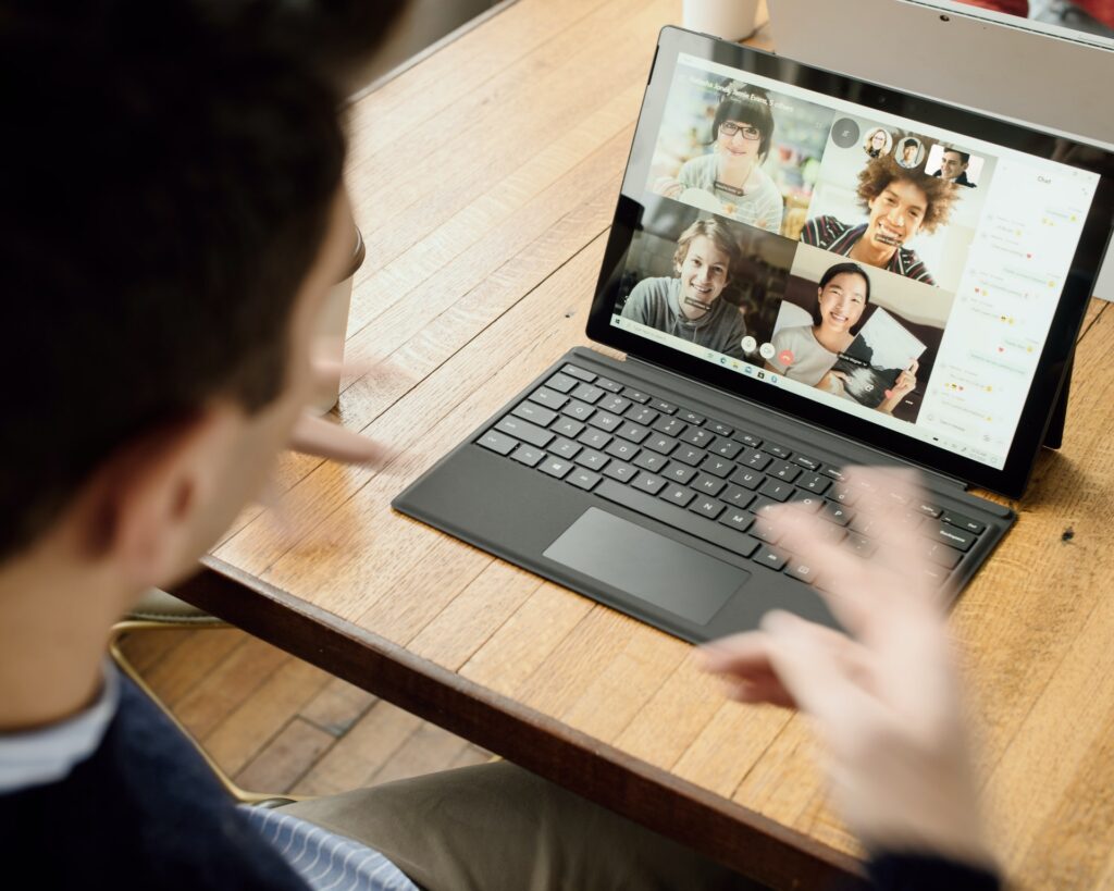 a remote team of hybrid employees participating in a video conference call together