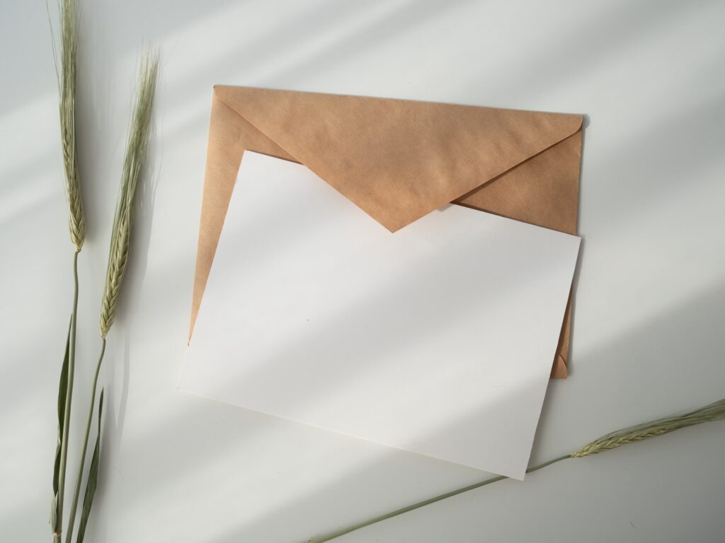 a blank card and an envelope sitting on a tabletop