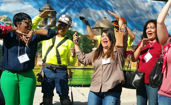 a group of colleagues taking part in random acts of kindness outdoor team building activity