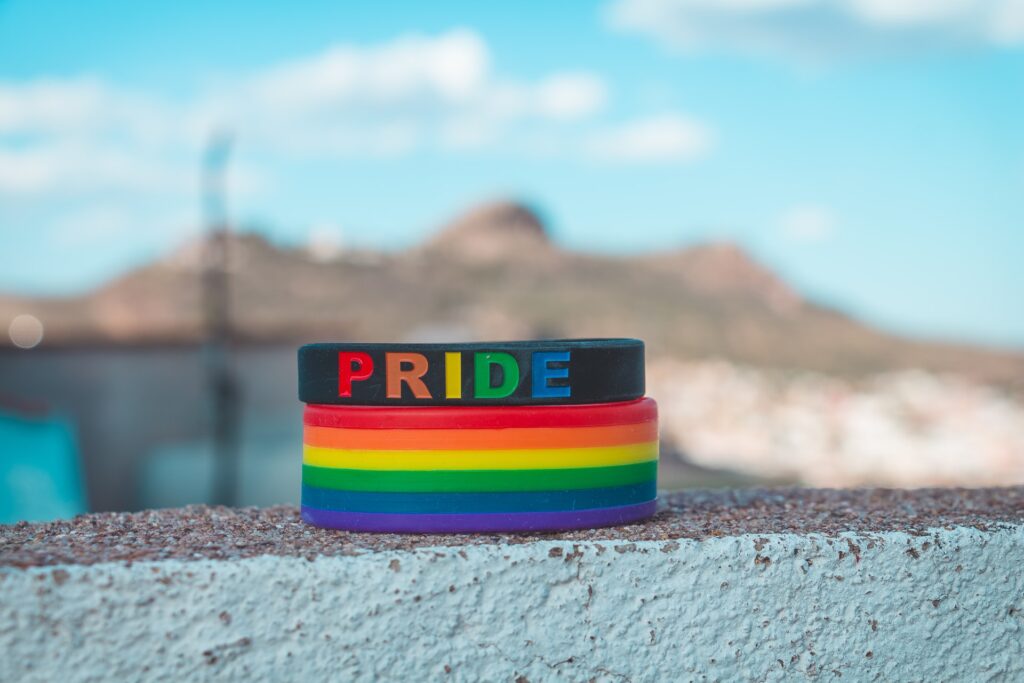 a stack of colorful celebratory bracelets for pride month