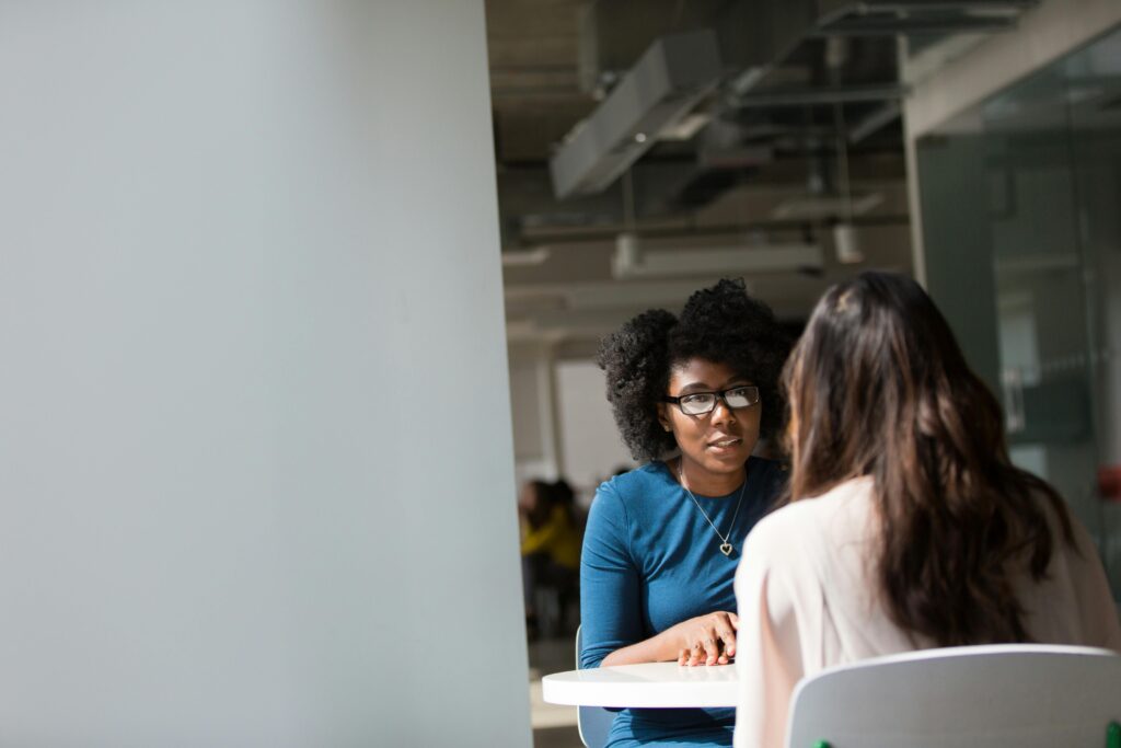 Two professionals having a focused one-on-one discussion – workplace feedback session and performance review concept.