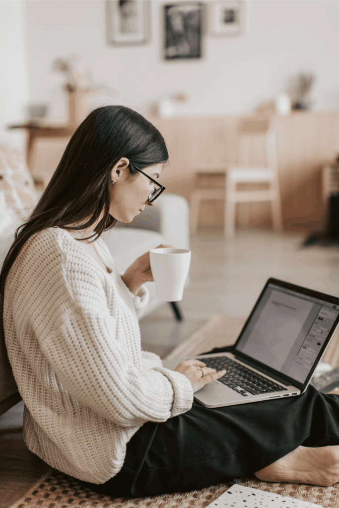 A remote employee enjoys coffee while engaging in virtual team-building activities from home.