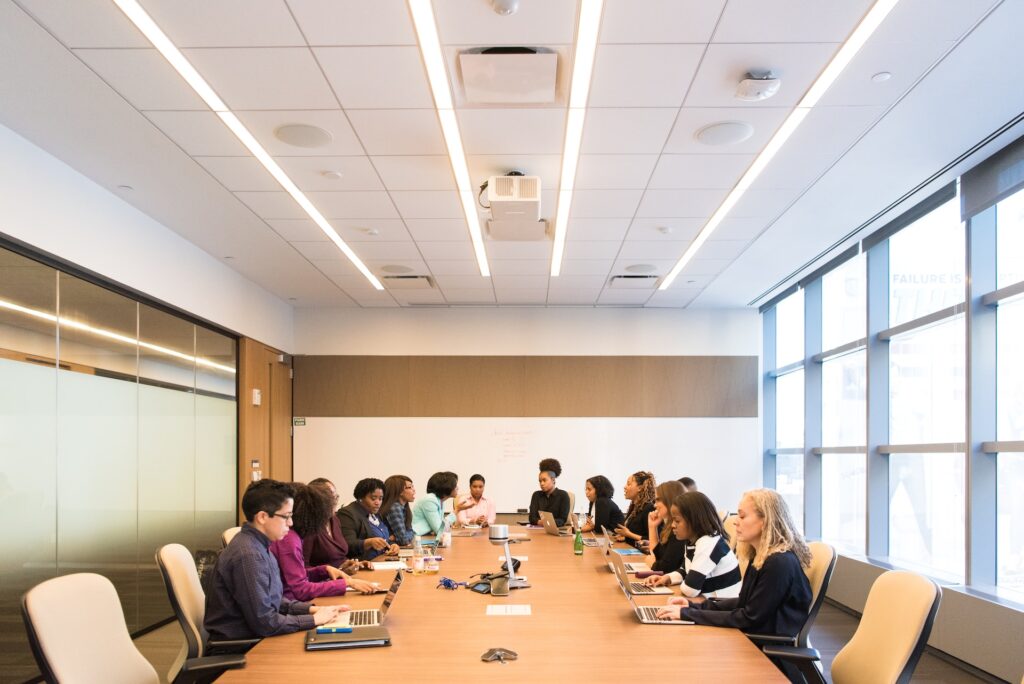 a corporate team sitting at a conference room table during a training and development session