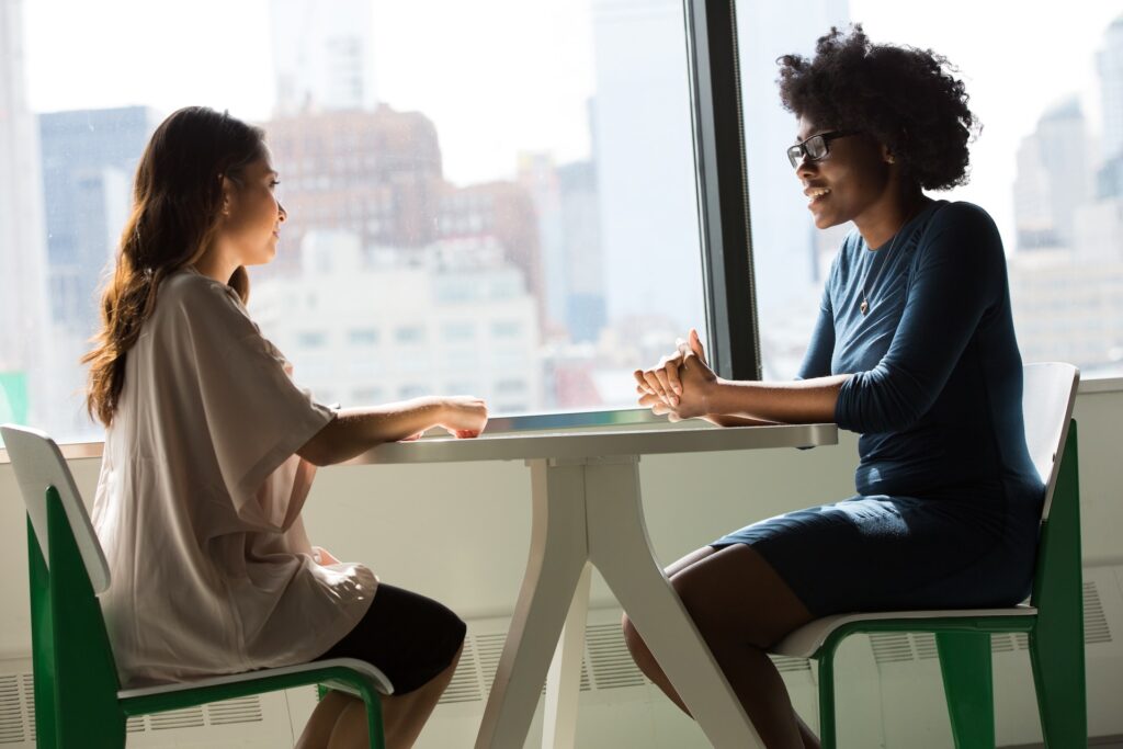 two women sitting at a desk during a job interview