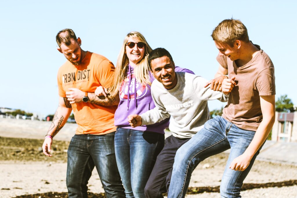 four coworkers outside enjoying a team outing together