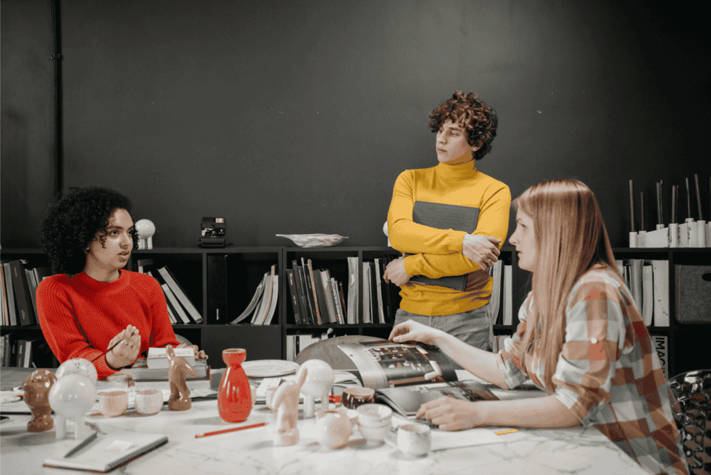 Employees networking and having casual conversations during an office break with drinks and snacks.
