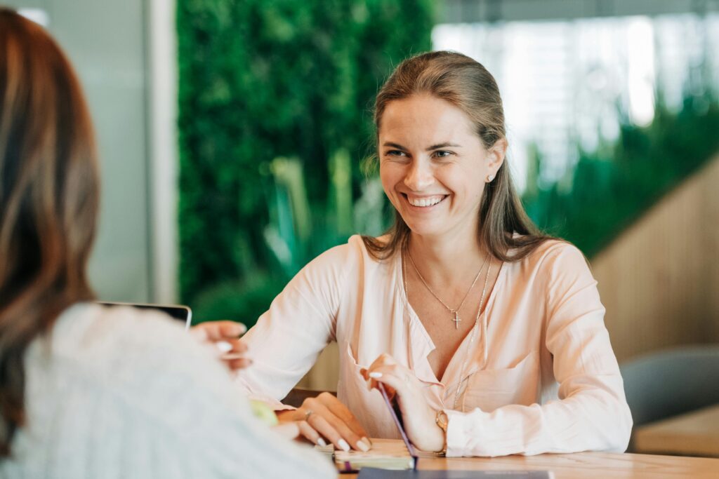 Woman smiling during a friendly conversation with a coworker