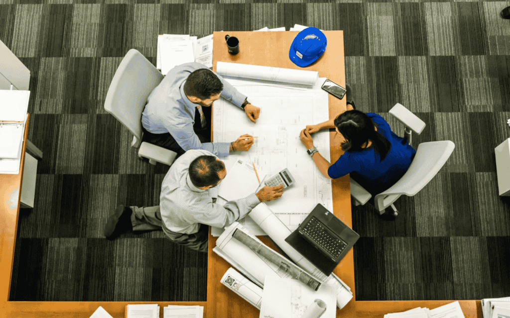 Team mates collaborating at a communal work table 