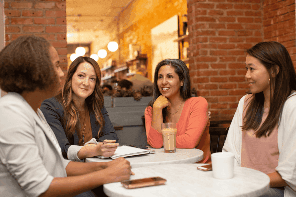 Colleagues having a business meeting and friendly discussion in a cozy café setting