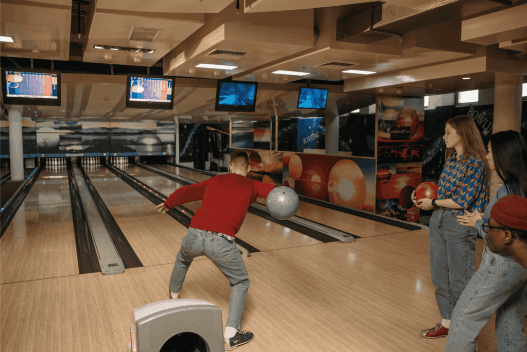 Friends enjoying a fun game of bowling at an indoor bowling alley