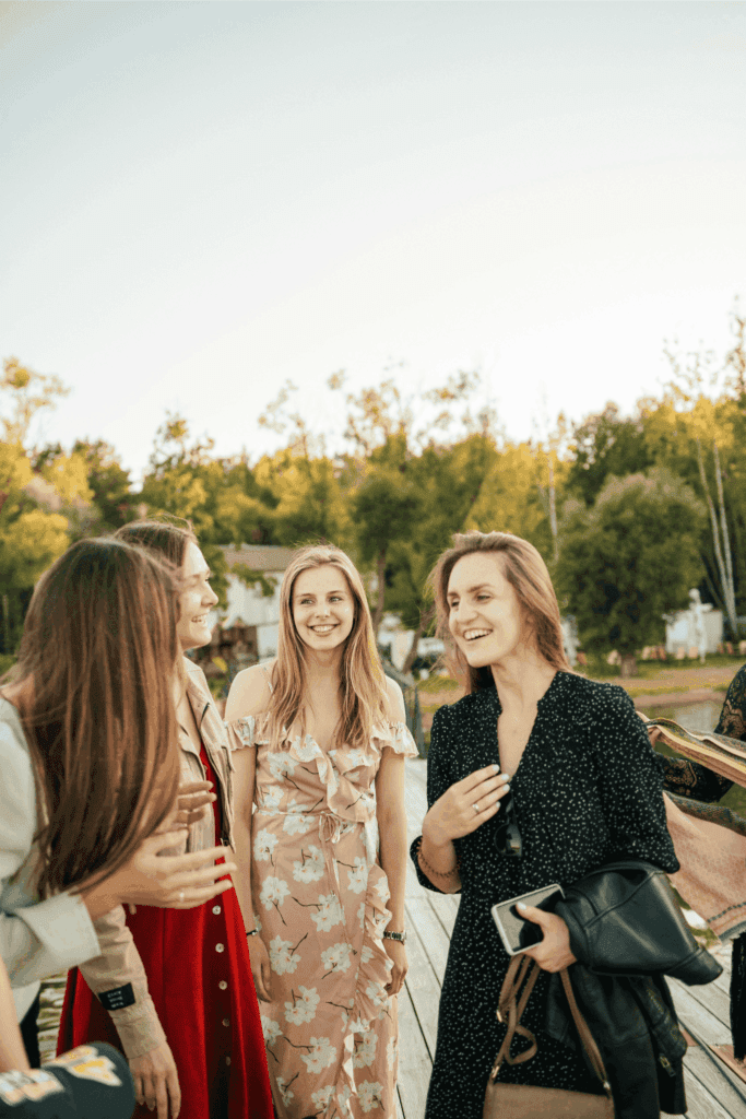 Group of friends enjoying a cheerful outdoor gathering on a sunny day
