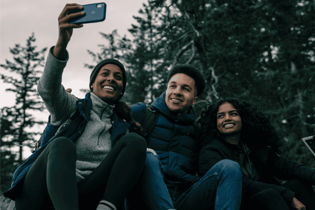 Friends enjoying an outdoor adventure and capturing memories with a selfie in nature