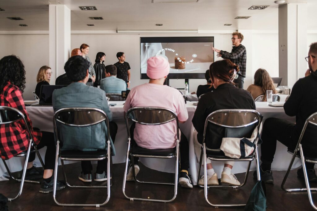 Team workshop with participants watching a group presentation on curation and review