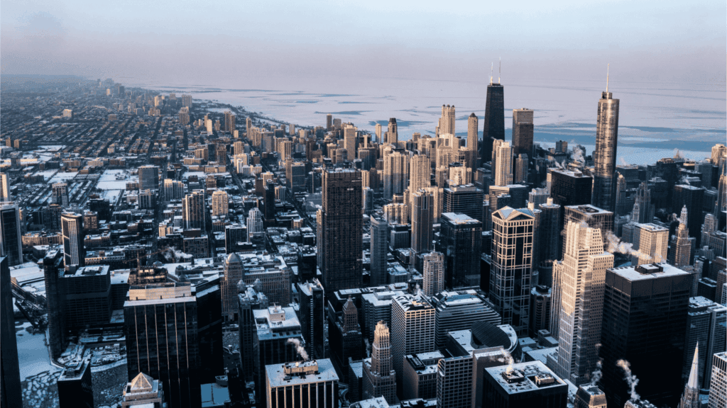 Aerial view of downtown Chicago skyline with high-rise buildings and Lake Michigan in the background on a winter day