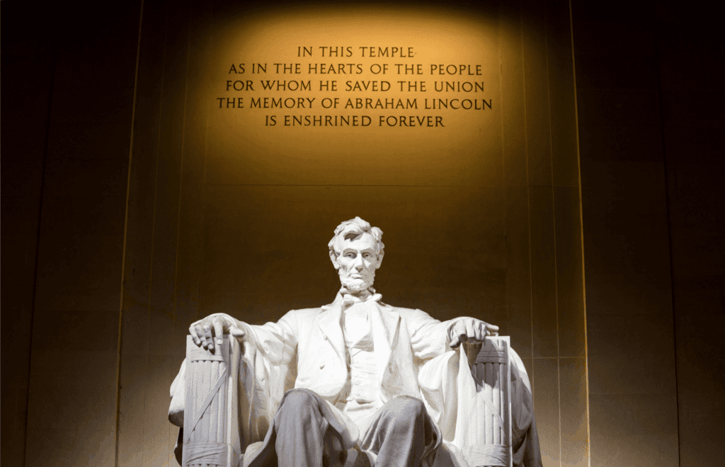 Statue of Abraham Lincoln at the Lincoln Memorial in Washington, D.C., with inscription honoring his legacy