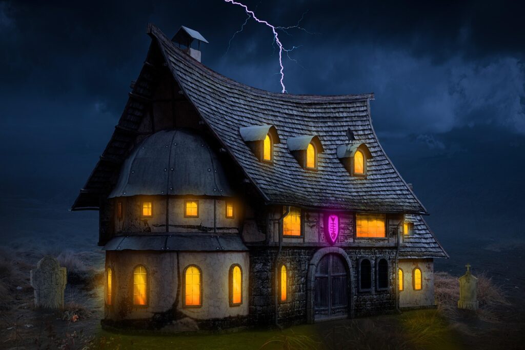 A spooky haunted house with glowing yellow windows under a stormy night sky, lightning striking above, and gravestones nearby, creating a chilling Halloween atmosphere.