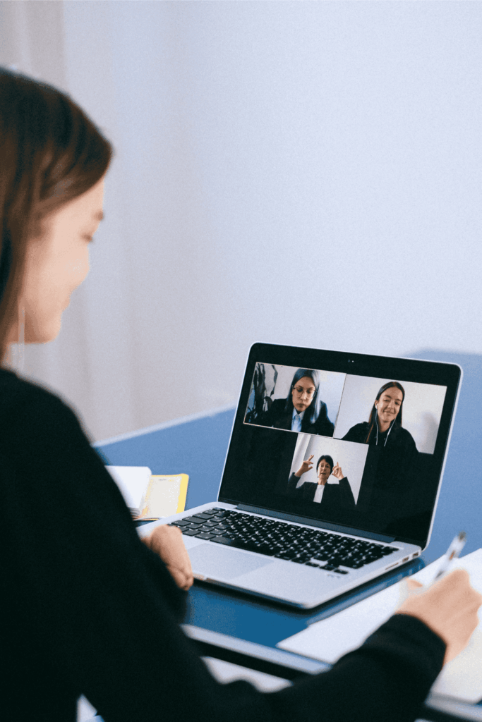 Employee participating in a virtual team meeting on her laptop